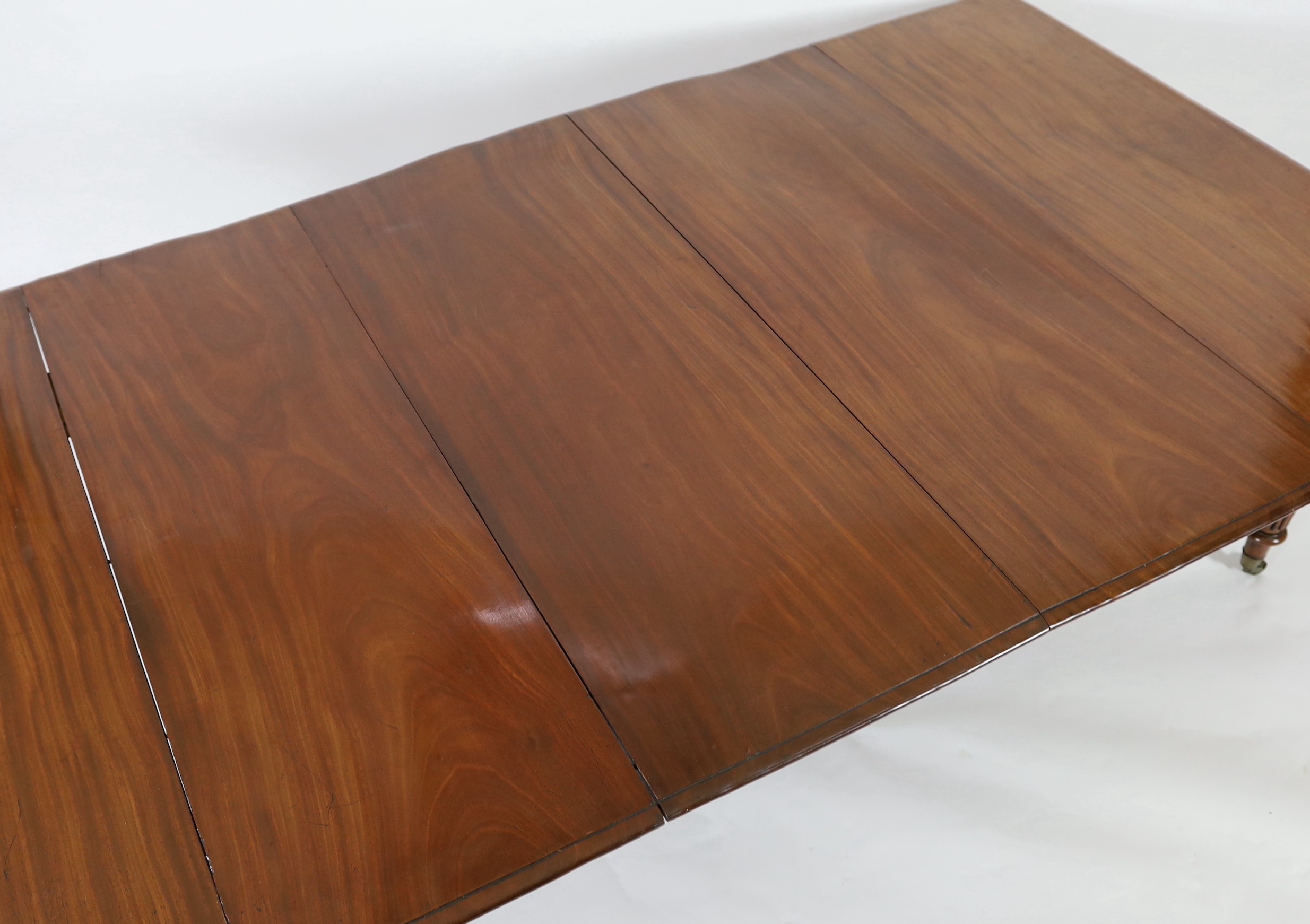A Regency mahogany extending dining table, extends to 306cm x 135cm H.72cm